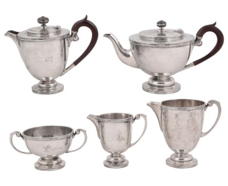 A George V silver five piece tea serviceof tapering form on a spreading domed foot with raised tooled borders, comprising tea