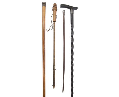 An Edwardian ebony walking stick with three othersto include a silver topped malacca cane, a Boys Brigade swagger stick and a