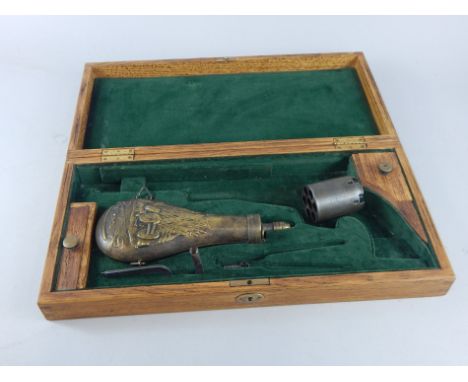 A 20thC light oak gun case, with fitted interior and a small quantity of contents, part etched six shot barrel, powder flask 