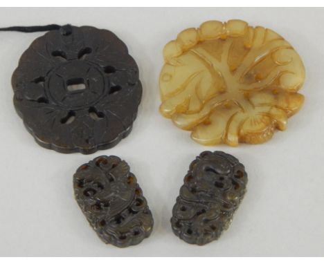 Four modern jade style pendants, to include two small carved dragon examples, and two oval pendants (4). 