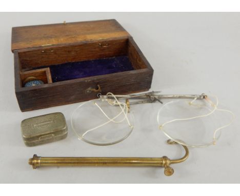 A set of portable scales, with brass support, glass trays, various weights, in a small oak case.