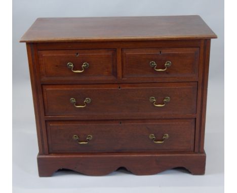 A 20thC mahogany chest, the over hanging top raised above two short and two long drawers, with a shaped apron base, with brac
