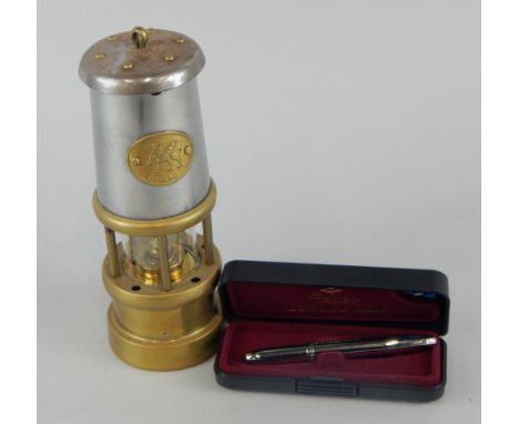 A reproduction brass Welsh miner's lamp, in original packaging, and a Fisher space pen, (2).