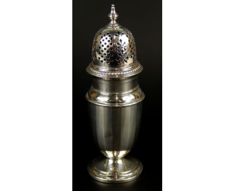 A George V silver sugar caster, with a turned finial and faceted body on a domed foot, Birmingham 1934, 4½oz, 18cm high.