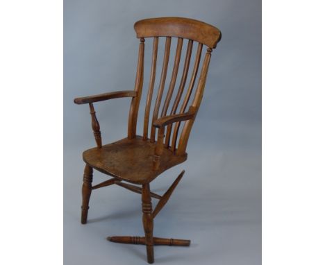 A late 19thC ash and elm grandfather chair, with comb top above serpentine square vertical rails, with turned seat, on ring t