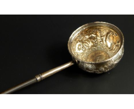 A silver toddy ladle, with whale bone handle, the circular bowl embossed with vines and inset with a Queen Anne 1705 coin, 37