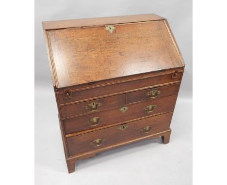 An 18thC oak bureau, the fall enclosing a fitted interior with a well, above two short and two long drawers, on bracket feet,