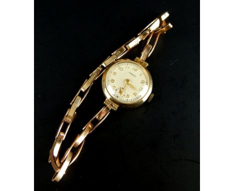 A Tissot ladies wristwatch, on 9ct gold expanding bracelet, gold plated watch head, 14.7g all in. 