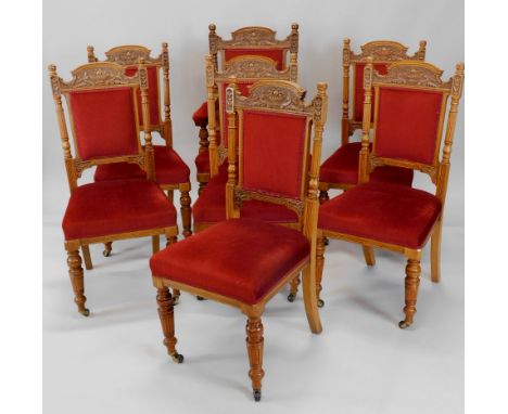 A late Victorian carved oak part salon suite, each piece carved with urns fruit, foliate scrolls, etc., to include an open ar