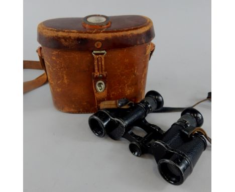 A set of German WWI binoculars by Zeiss, stamped D.F.6x672104, the leather case inset with a compass.