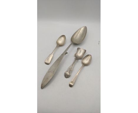 A white metal Continental basting spoon, along with two teaspoons and silver caddy spoon with a floral pierced terminal, tota