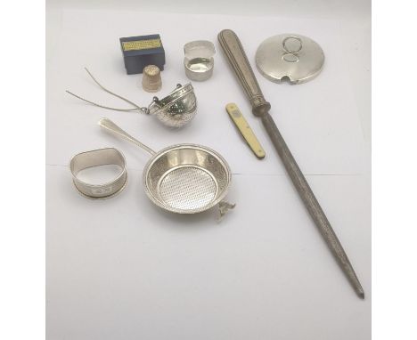 Mixed silver to include two tea strainers, napkin ring, silver thimble and other items along with a pen knife LocationIf ther