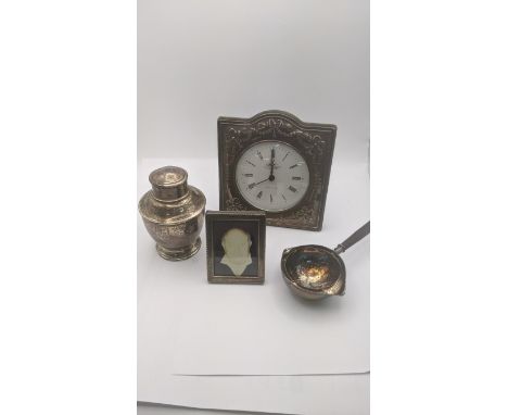 Mixed silver items to include a tea caddy pot 91.9g, silver fronted desk clock, photo frame and a silver plated tea strainer 
