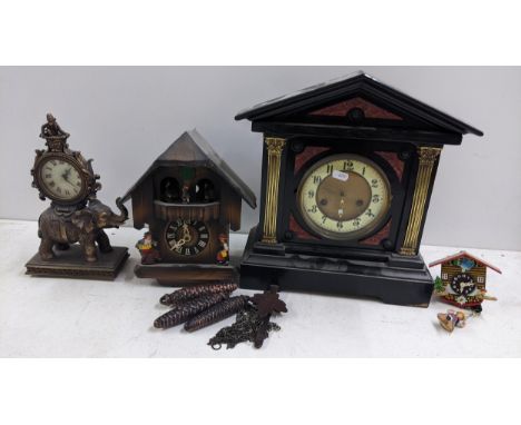 Four clocks to include a mid 20th century cuckoo clock, Victorian ebonised mantel clock and othersLocation: A1MIf there is no