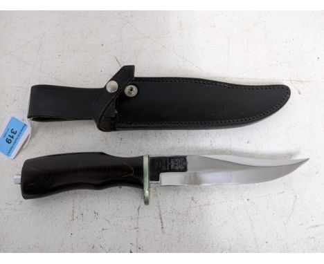 A Wilkinson Sword Bowie knife with wooden handle and black leather sheath, blade 14.5cm long Location: RWBIf there is no cond