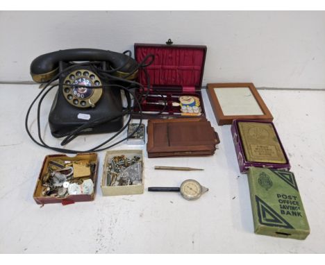 A mixed lot to include Post Office saving banks, miscellaneous buttons, badges and chains, a decorative Zippo lighter, a prop