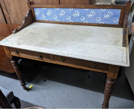 A Victorian oak tile back washstand, 3/4  quarter framed gallery back with six aesthetic blue and white insert tiles on a whi