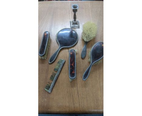 A six-piece silver and tortoiseshell dressing table set A/F to include a comb, mirror, two hand brushes and two other brushes