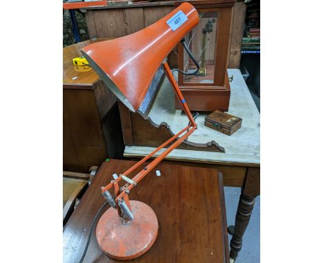 A mid-century Anglepoise Lighting Company desk light BS4533 2.4 on a circular base finished in an orange colour Location: GIf