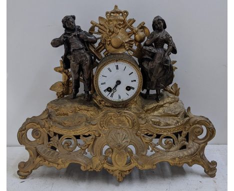 A late 19th century French gilt metal mantel clock, the drum head cock flanked by two figures, the 8-day Japy Freres movement