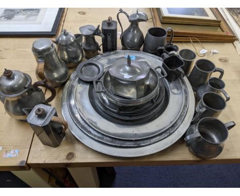 A selection of 18th, 19th and 20th pewter wares to include chargers, plates a manor pewter tea caddy with hammered decoration