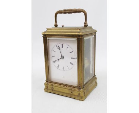A late 19thC Brass carriage clock, with white enamel dial signed Dent, quarter repeating with carriage case 17cm in Height 