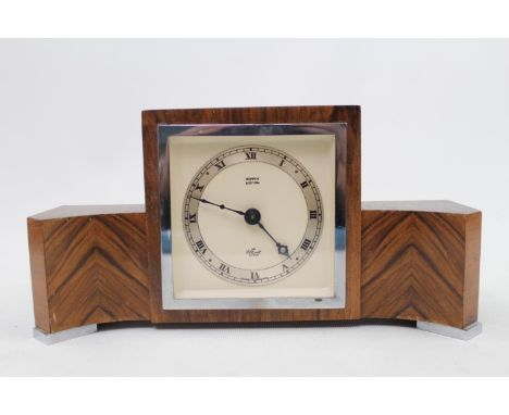 Hopper of Boston Elliott clock with quartered veneer with serpentine breakfront 