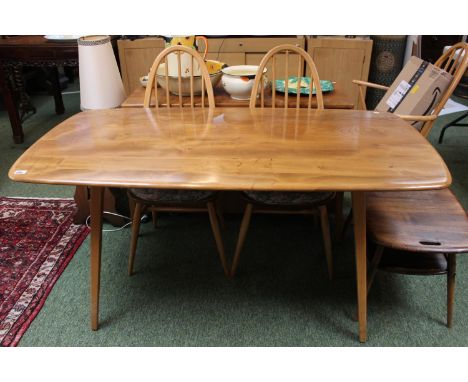 Ercol Blonde Elm dining table on outstretched legs and a matching set of 6 Ercol Windsor chairs 