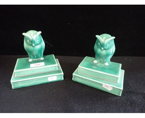 A PAIR OF GREEN ART DECO CERAMIC BOOKENDS in the form of owls, stamped, 'Arden', 13.5cm high