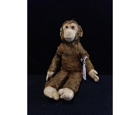 A VINTAGE PLUSH TOY MONKEY with felt feet hands and face