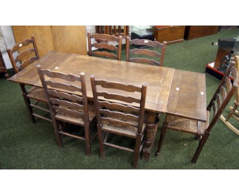 An oak priory-style draw-leaf dining table, together with a set of six ladder-back chairs, for restoration 