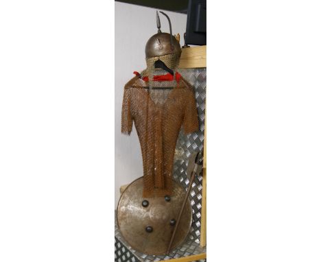 A suite of Indo-Persian armour, including a decorated helmet (Kulah-Khud) and shield (Dhal), a chainmail tunic of typical for