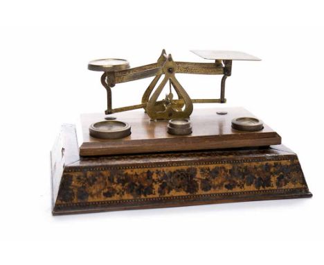 SET OF POSTAL SALESOn an inlaid mahogany base, with four stacked weights; together with an Allbrit Fixed Arm Planimeter and a