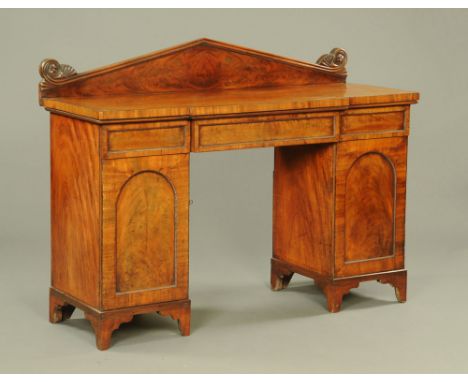 A 19th century mahogany sideboard, with triangular and scroll carved rear pediment and fitted with a series of drawers and cu