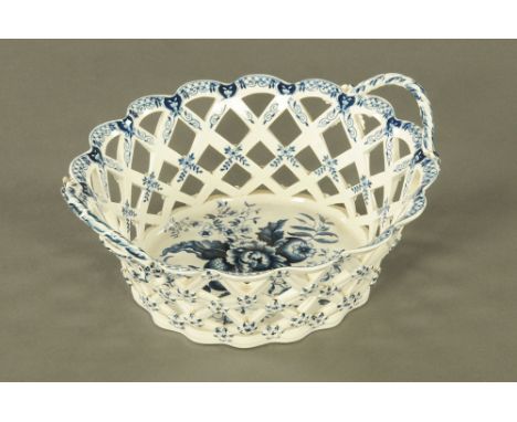 An 18th century Caughley blue and white porcelain reticulated oval basket, decorated with flowers and leaves.  11 cm high, 28