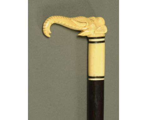 A late Victorian hardwood walking stick, with carved ivory elephant head terminal.  Length 92.5 cm.