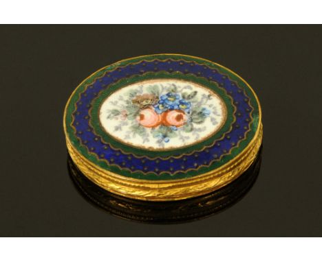 A late 18th/early 19th century continental gilt metal oval patch box with internal mirror, the lid enamelled with floral spra