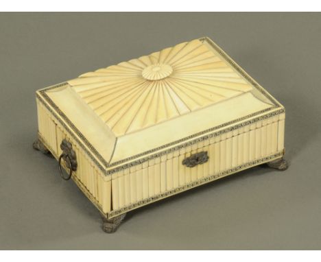 A 19th century Anglo Indian ivory workbox, of neoclassical style with ebonised scrolled leaf borders and bandings, cast metal