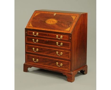 A George III mahogany bureau, with satinwood banded boxwood and ebony strung edge and with shell inlay to the flap.  With wel