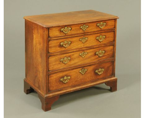 A George III mahogany chest of drawers, with moulded edge above four long graduated drawers with brass drop handles and pierc