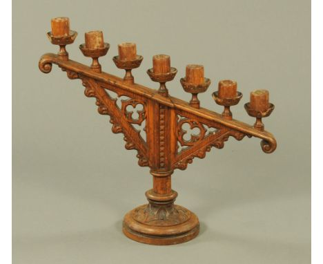 A late 19th century Gothic oak candlestick.  Height 52 cm, width 55 cm.