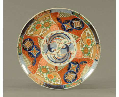 A 19th century Japanese porcelain charger, decorated in the Imari palette with phoenix, flowers and geometric motifs.  45 cm 