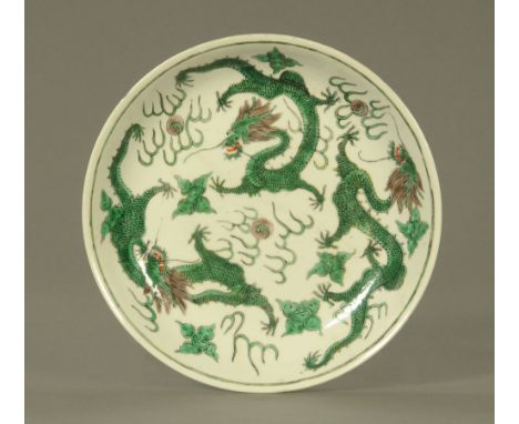 A Chinese dragon bowl, decorated with painted chasing dragons and with red seal mark to base, restored.  Diameter 24.5 cm. CO