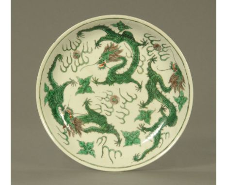 A Chinese dragon bowl, decorated with painted chasing dragons and with red seal mark to base, restored.  Diameter 24.5 cm. CO