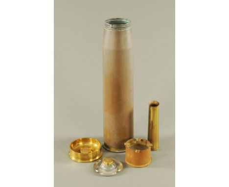 A collection of Trench Art, together with a brass mounted inkwell and large shell case.
