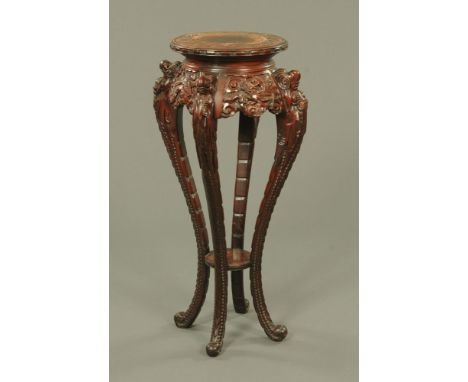 A Chinese carved softwood jardiniere stand, raised on four cabriole type legs with scroll feet.  Height 91 cm, top diameter 3