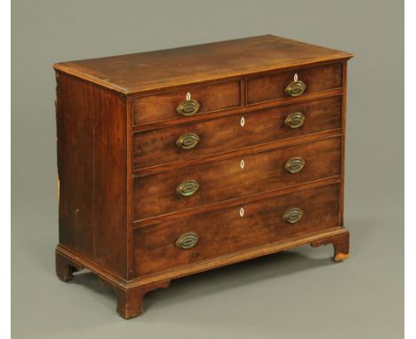 A George III mahogany chest of drawers, with boxwood strung top and moulded edge above two short and three long graduated dra