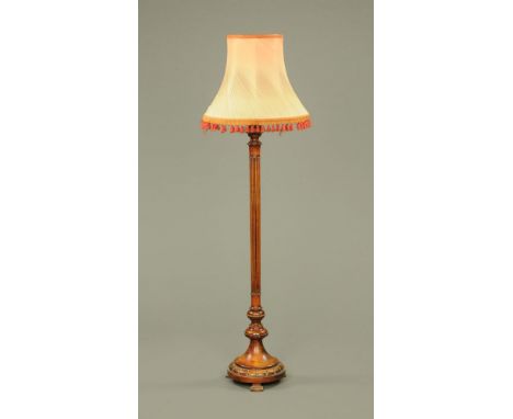 A 1920's mahogany standard lamp, with reeded column on moulded circular base and sold with silk tasselled shade.  190 cm high