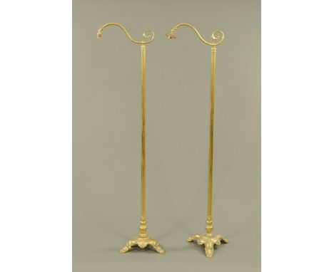 A pair of brass lamp standards, triform bases.  Maximum height 171 cm.