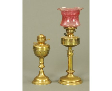 A Victorian brass table oil lamp, the reservoir with classical scene of urns and swags, on plain cylindrical stem and circula